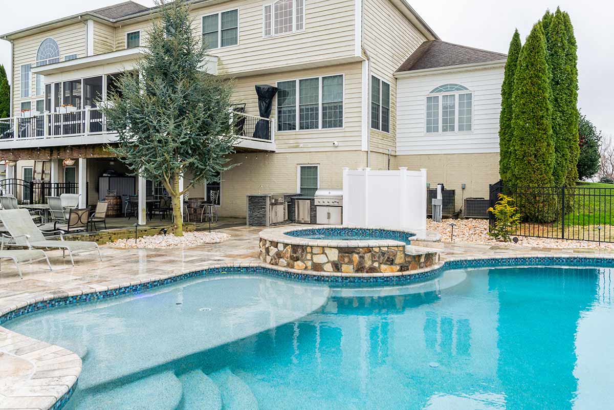Custom pool with hot tub and outdoor kitchen