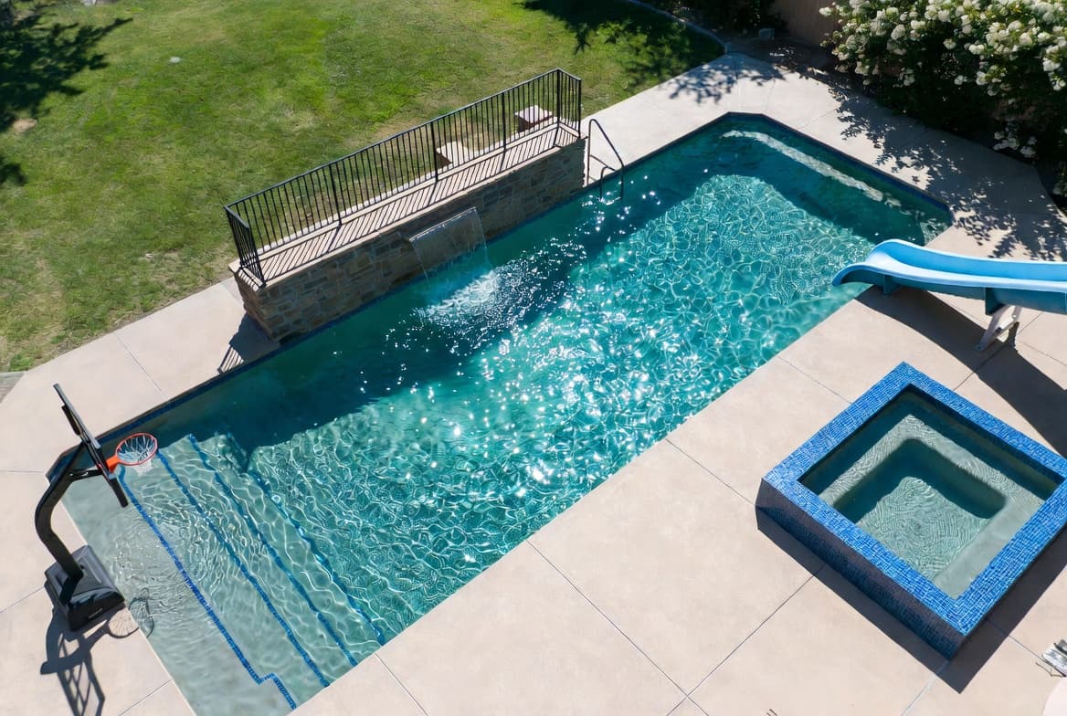 Aerial view of pool with hot tub and slide